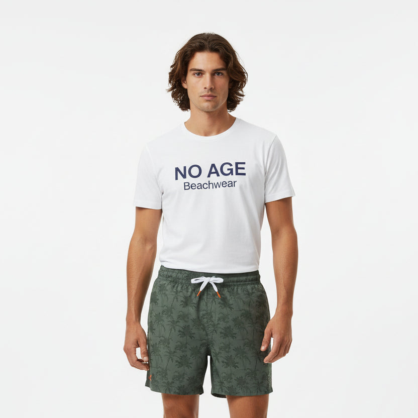 Homme short de bain NO AGE avec motif palmier, couleur vibrante, conçu pour la plage et les activités aquatiques.
